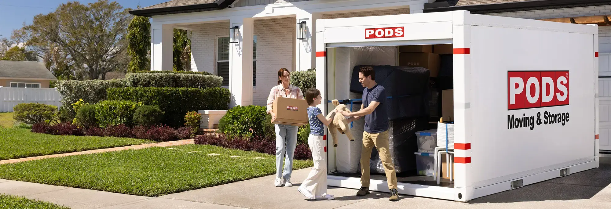 A family a PODS container in their driveway